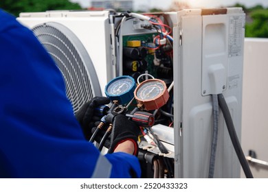 Air conditioner service .The air conditioner technician is using a gauge to measure the refrigerant pressure. air compressor.