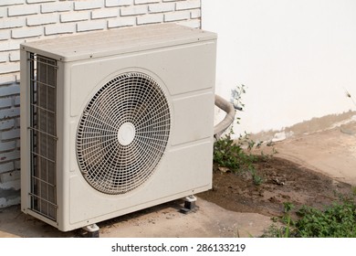 Air conditioning compressor unit is outside of building - Shutterstock ID 286133219