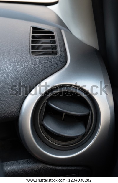 Air conditioning holes in car interior. Air\
ventilation inside driver\
place.