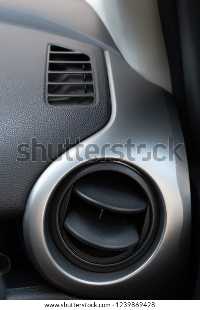 Air conditioning holes in car interior. Air\
ventilation inside driver\
place.