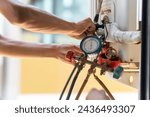 Air Conditioning Repair, Repairman fixing air conditioning system, Male technician service for repair and maintenance of air conditioners