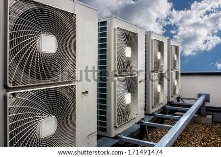 Air conditioning system assembled on side of a building.