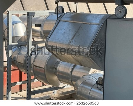 The air conditioning system of an office complex is mounted on the roof of the building, the cooling circuits and pressure instruments can be seen, behind them the roof
