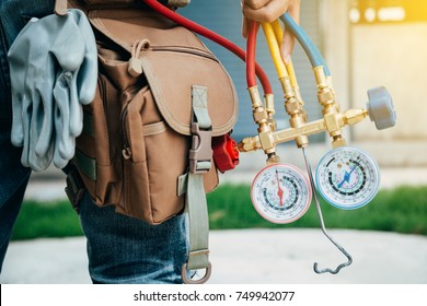 Air Conditioning Technician and A part of preparing to install new air conditioner. - Shutterstock ID 749942077