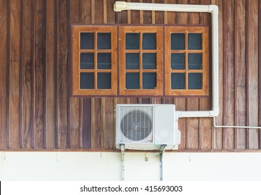 Air Conditioning Units Installed Outside The House On Wooden Wall