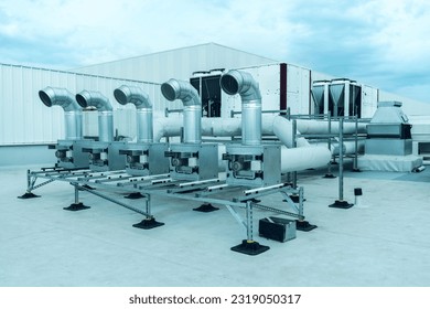 The air conditioning and ventilation system of a large industrial building is located on the roof. It consists of air ducts, air conditioning, smoke removal and ventilation