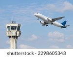 Air control tower and airplane on blue and cloudy sky background. Istanbul Ataturk airport air control tower. No people, nobody. Horizontal photo. Airline transportation idea concept.

