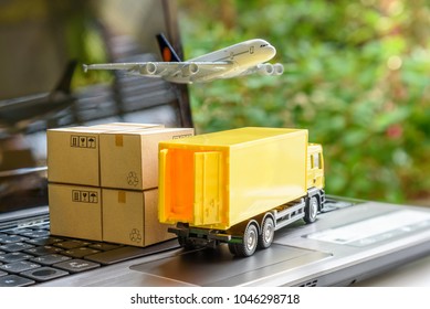 Air courier / freight forwarder or shipping service concept :  Boxes, a truck, white plane flies over a laptop, depicts customers order things from retailer sites via the internet and ship worldwide.