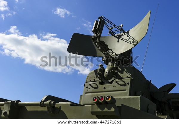 Air defense radar of military mobile mighty\
missile launcher system of green color, modern army industry, white\
cloud and blue sky on background\
