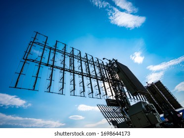 Air Defense Radars Of Military Mobile Antiaircraft Systems, Modern Army Industry On Background Beautiful Clouds And Blue Sky