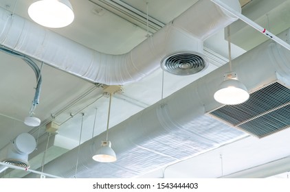 Air Duct, Air Conditioner Pipe And Fire Sprinkler System On White Ceiling Wall. Air Flow And Ventilation System. Building Interior. Ceiling Lamp Light With Opened Light. Interior Architecture Concept.