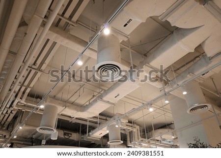 Air duct, air conditioner pipe, wiring pipe, and fire sprinkler system. Air flow and ventilation system. Building interior. Ceiling lamp light with opened light. Interior architecture concept.