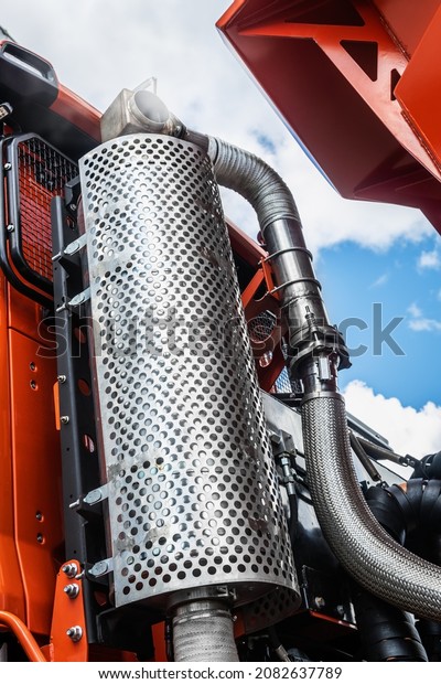 an air filter and a running truck engine against
the background of clouds