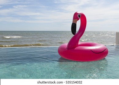 Air flamingos balloon float in the swimming pool by the sea