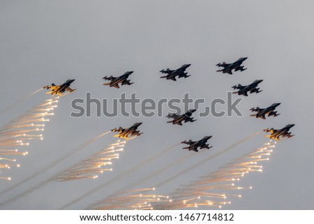 Air force fighter jet planes formation firing flares.