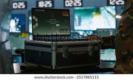 Air force officer performing tactical level surveillance in command room using laptop. Close up of military specialist in base of operations using radar on notebook to look at assault zones, camera A