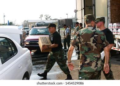 Air Force Sergeant Loads Emergency Supplies Into Civilian Car. Taken At Keesler AFB, MS On September 10, 2005.