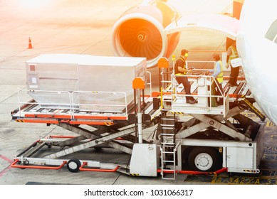 Air Freight Services Or Airplane Transportation, Operator Loading Cargo On Plane In Airport.