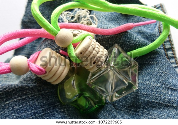 Air freshener for car, perfume and hygiene with jeans\
background. 