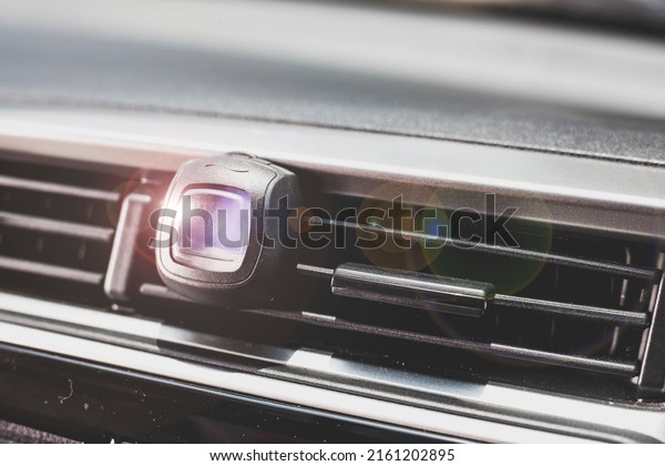 Air freshener in\
the car air vent. close-up