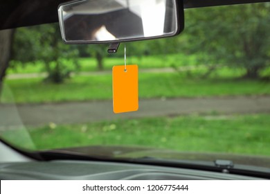 Air Freshener Hanging In Car Against Windshield