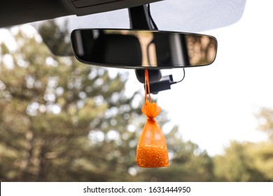 Air Freshener Hanging On Rear View Mirror In Car