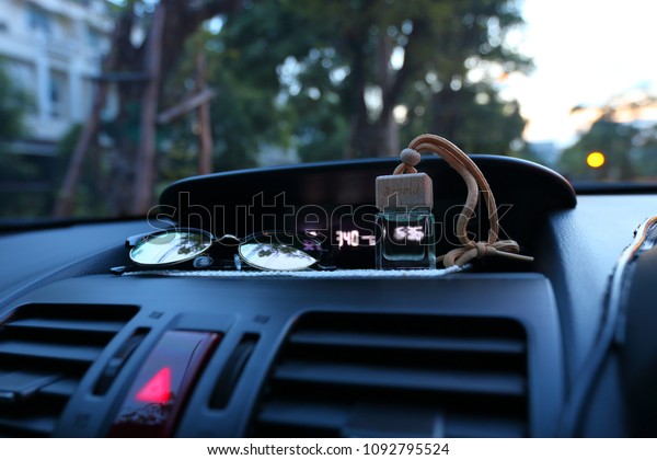 Air freshener on car\'s dashboard in clean air and\
refreshment on travel\
concept