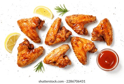 Air fryer chicken wings glazed with hot chilli sauce and served with different sauces.  isolated on white  background . top view