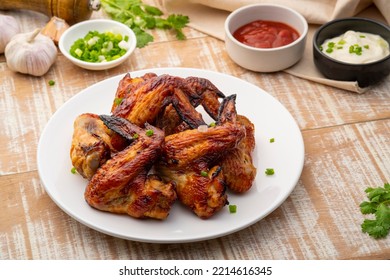 Air Fryer Grilled Chicken Wings On White Plate,served With Ketchup And Mayonnaise