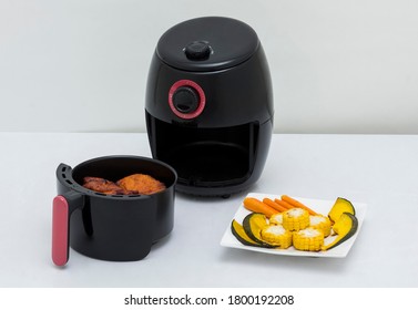 Air Fryer Machine With Chicken And Vegetables On White Background