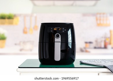 Air fryer machine cooking potato fried in kitchen.  Lifestyle of new normal cooking. 