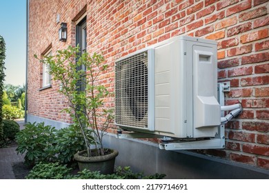 Air to air heat pump for cooling or heating the home. Outdoor unit powered by renewable energy. - Shutterstock ID 2179714691