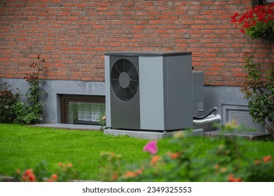 Air heat pump installed on the exterior facade of the old house. Sustainable heating solutions for old construction. Air source heat pump beside residential country cottage. - Shutterstock ID 2349325553