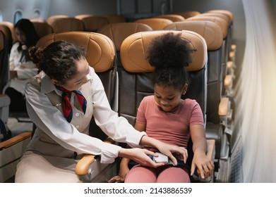 Air hostess is fastening the child's safety belt.