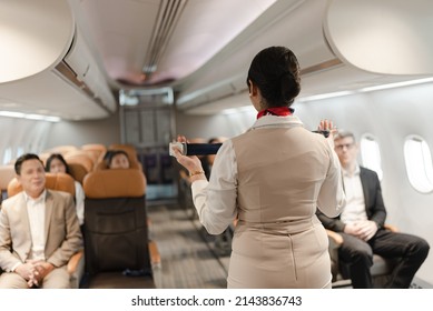 Air hostess, operator explaining passengers how to use seat belt in the plane 