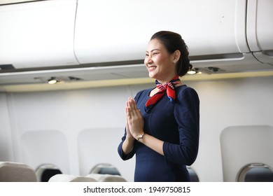 Air Hostess Or Stewardess Service ,  Attractive Woman Stewardess And Background Of Plane, Asian Flight Attendant Posing With Smile At Middle Of The Aisle Inside Aircraft Passenger Seat 