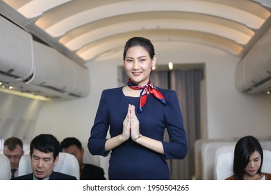 Air Hostess Or Stewardess Service , Young Slim And Atractive Woman Stewardess And Background Of Plane, Asian Flight Attendant Posing With Smile At Middle Of The Aisle Inside Aircraft Passenger Seat 