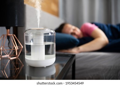 Air Humidifier Steam On Nightstand Near Young Lady Sleeping