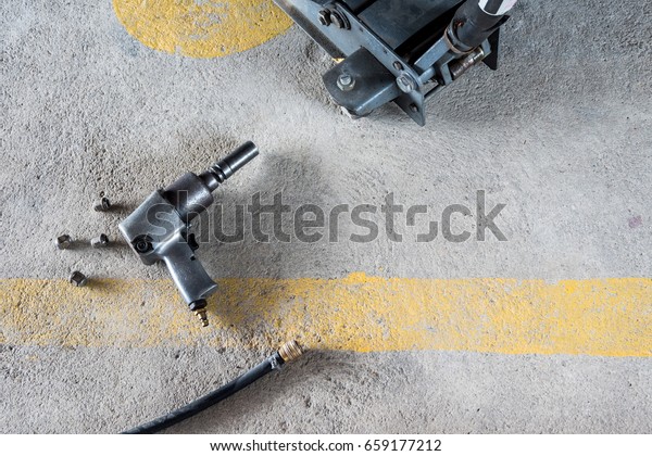 Air impact  wrench\
and bolts on the floor.