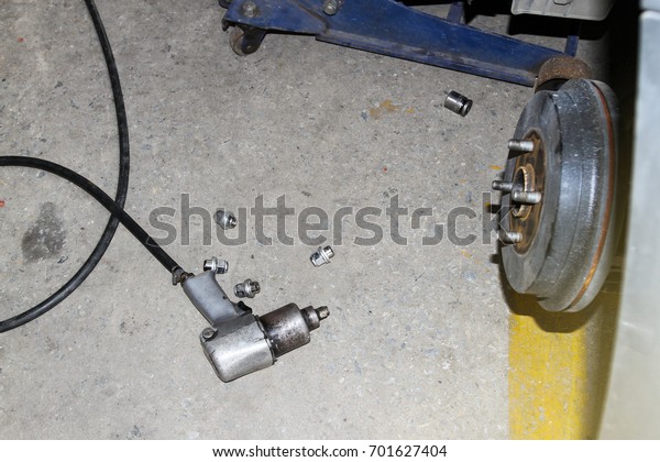 Air impact wrench\
and bolts on the floor.