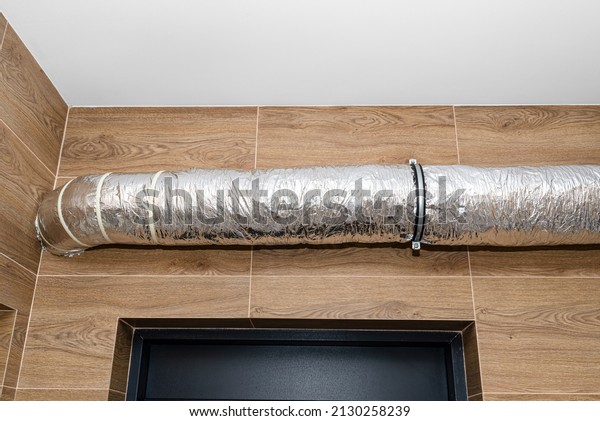 Air intake and exhaust in the home mechanical
ventilation with heat recovery with visible insulated pipes with
silver foil entering the
wall.