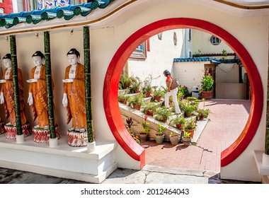  Air Itam Penang Malaysia November 11 2017. Woman Walking Up The Stairs Inside A Temple Area In Kek Lok Si. Circle Formed Opening In A Wall. Identical Statues In Buddhist Temple In Malaysia.