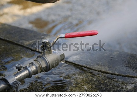 An air line in a compressed air system is drained via a valve.