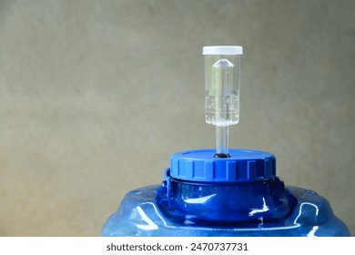 Air locker tool on plastic ferment of wine in progess of making homemade wine  - Powered by Shutterstock