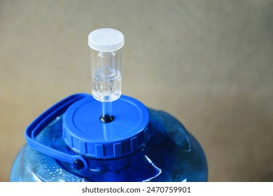 Air locker tool on plastic ferment of wine in progess of making homemade wine  - Powered by Shutterstock