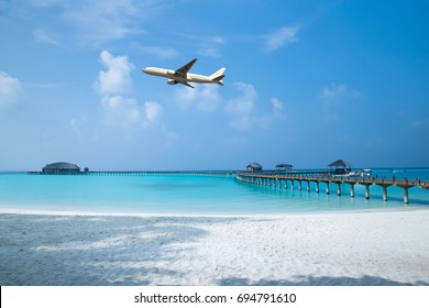 Air Plane Fly Over The Sand Beach And Blue Sea 