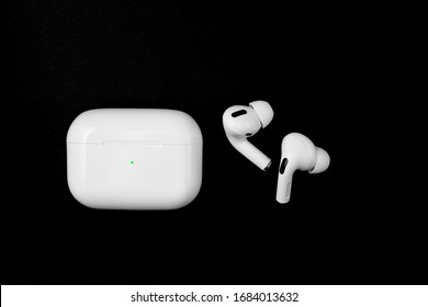 Air Pods Pro. with Wireless Charging Case. New Airpods pro on black background. Airpods Pro. Copy space