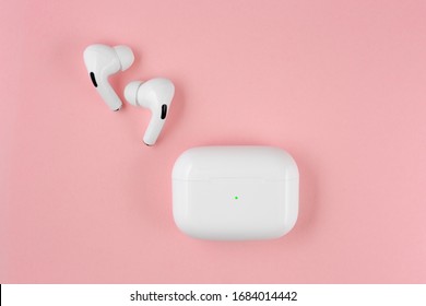 Air Pods pro. with Wireless Charging Case. New Airpods pro on pink background. Airpodspro. female headphones. 