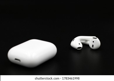 Air Pods. with Wireless Charging Case. New Airpods 2019 on black background. Airpods.EarPods.