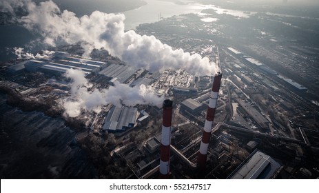 Air Pollution By Smoke Coming Out Of Two Factory Chimneys. Industrial Zone In The City. Kiev, Ukraine, Aerial View